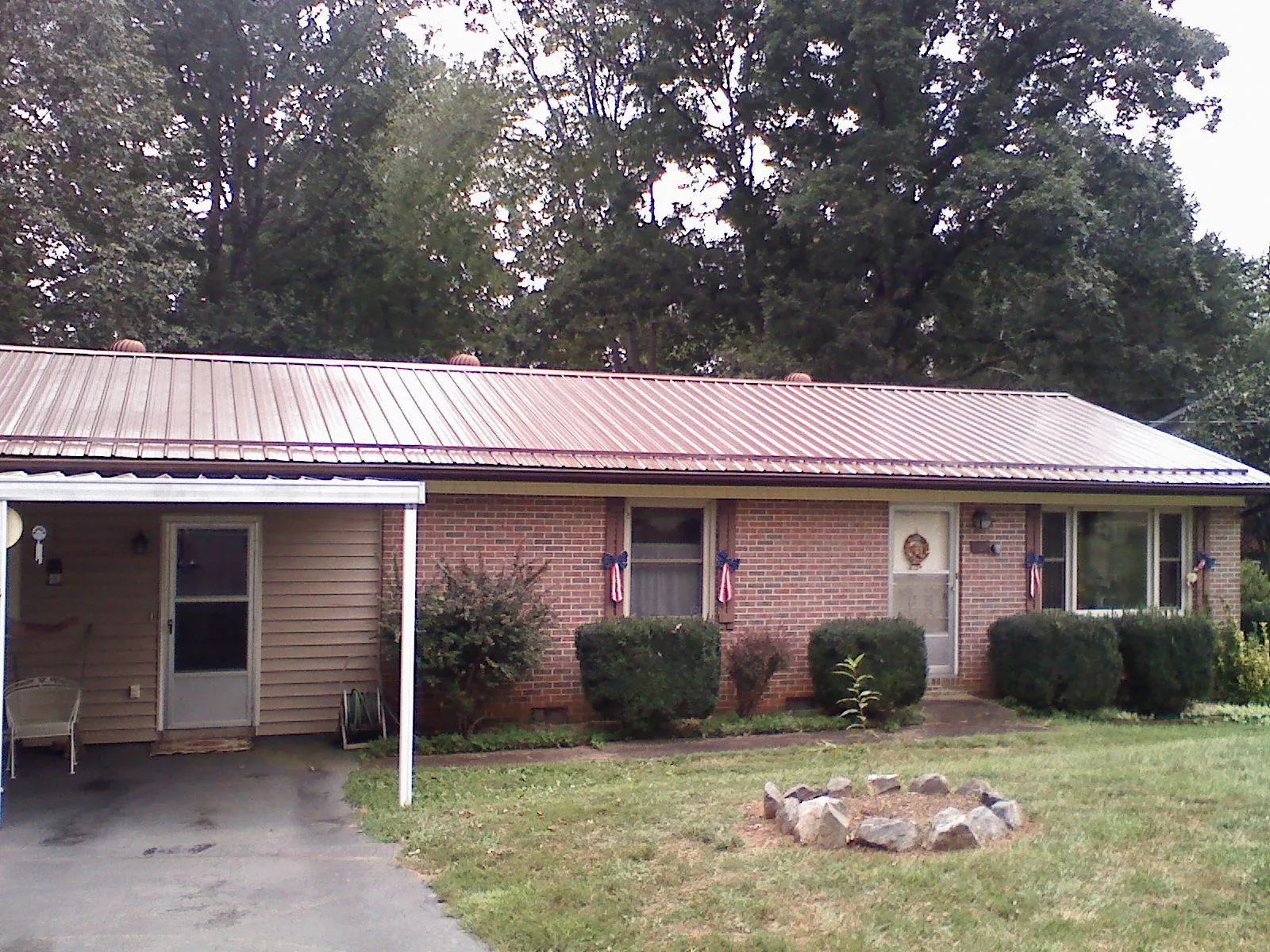 Bronze metal roof and carport on a brick ranch home — Roof Repair work by our crew in Monrovia